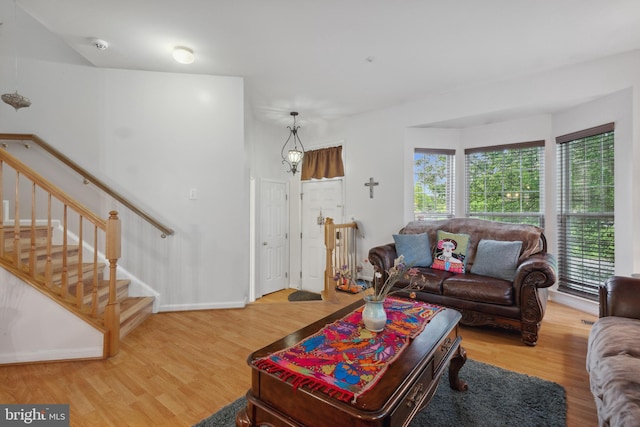 5533 Westcott Cir, Frederick, MD 21703 - living area with plenty of natural light, wood finished floors, baseboards, and stairway