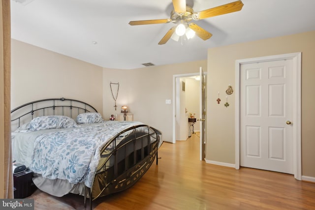 5533 Westcott Cir, Frederick, MD 21703 - bedroom with light wood finished floors, ceiling fan, and baseboards
