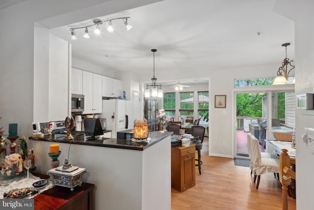 5533 Westcott Cir, Frederick, MD 21703 - kitchen featuring appliances with stainless steel finishes, light wood finished floors, a peninsula, ceiling fan, and white cabinetry