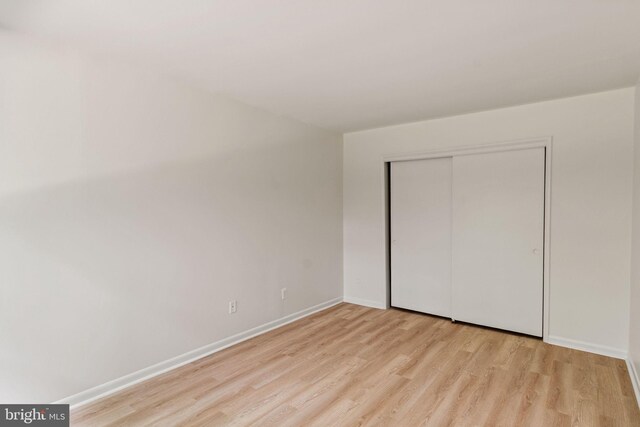 4931 Americana Dr Unit 4931B, Annandale, VA 22003 - unfurnished bedroom with light wood finished floors, baseboards, and a closet