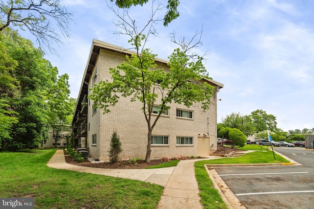 4931 Americana Dr Unit 4931B, Annandale, VA 22003 - view of property exterior featuring brick siding, uncovered parking, and a yard