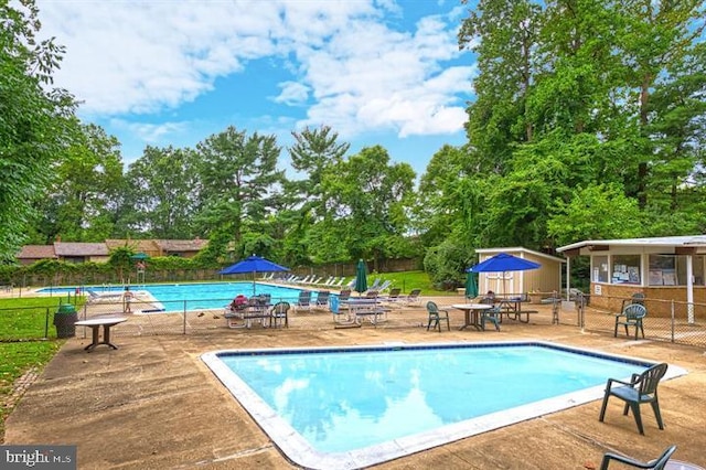 4931 Americana Dr Unit 4931B, Annandale, VA 22003 - community pool featuring fence, a patio area, an outdoor structure, and view of scattered trees