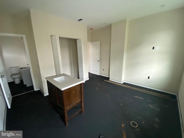 2710 Jefferson St, Baltimore, MD 21205 - unfurnished bedroom with dark colored carpet, a sink, and baseboards