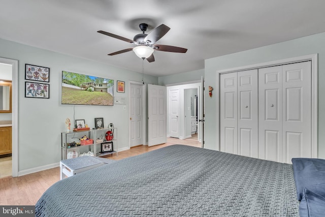 486 Round Up Rd, Lusby, MD 20657 - bedroom featuring light wood-style flooring, baseboards, a ceiling fan, a closet, and connected bathroom