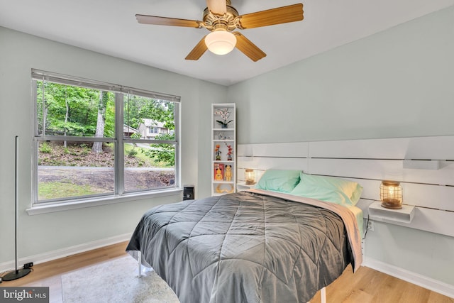 486 Round Up Rd, Lusby, MD 20657 - bedroom featuring baseboards, multiple windows, wood finished floors, and a ceiling fan