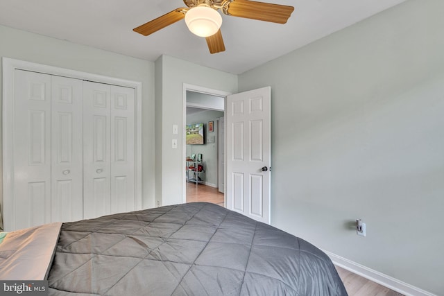 486 Round Up Rd, Lusby, MD 20657 - bedroom with baseboards, a closet, wood finished floors, and a ceiling fan