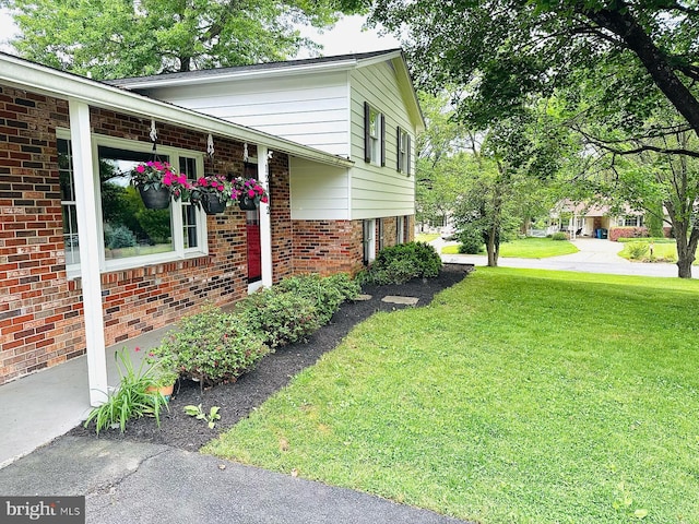 12112 Bayswater Rd, Gaithersburg, MD 20878 - view of property exterior featuring a yard and brick siding