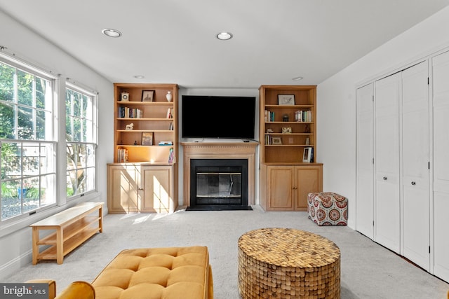 living room featuring plenty of natural light, carpet floors, a fireplace with flush hearth, and recessed lighting
