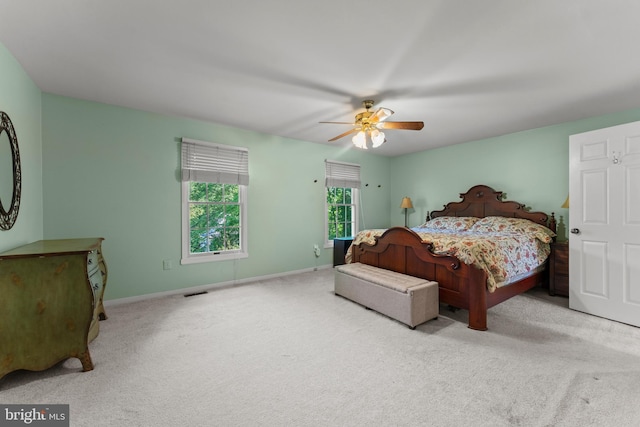 carpeted bedroom featuring baseboards and a ceiling fan