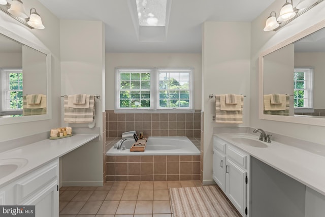 bathroom featuring tile patterned floors, two vanities, and a garden tub