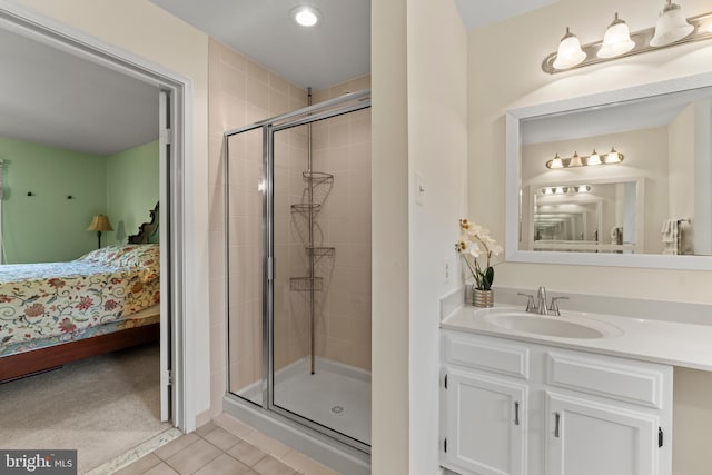 ensuite bathroom with a stall shower, tile patterned flooring, recessed lighting, and vanity