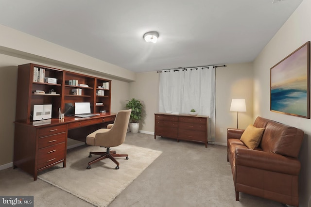 office with light colored carpet and baseboards