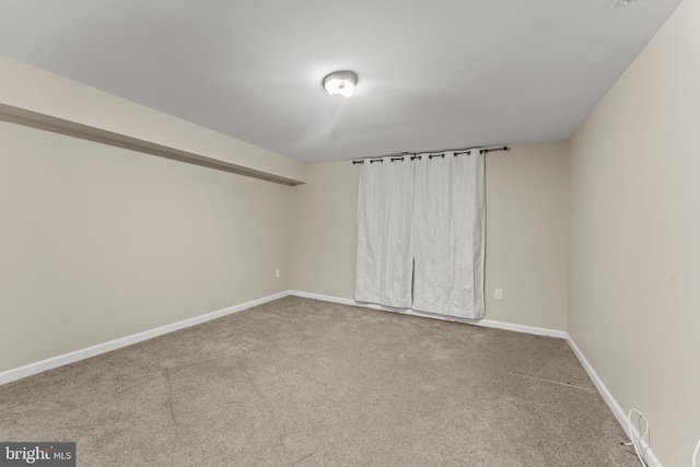 carpeted empty room with baseboards