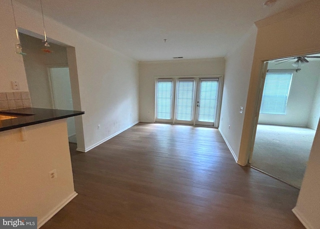 interior space with baseboards and dark wood-style flooring