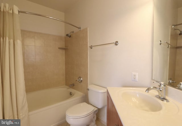 bathroom featuring vanity, shower / tub combo with curtain, and toilet