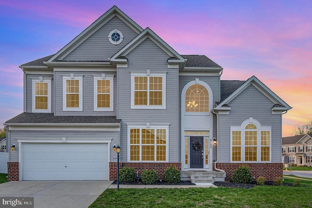 view of front of property featuring an attached garage, concrete driveway, brick siding, and a shingled roof
