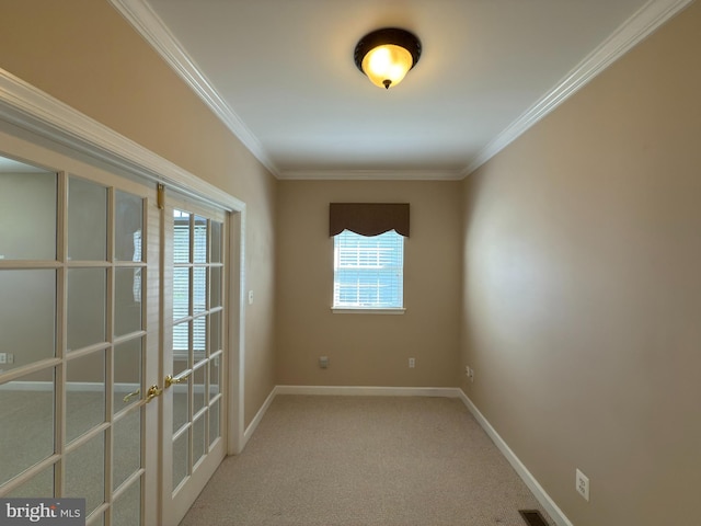 spare room featuring baseboards, french doors, crown molding, and carpet