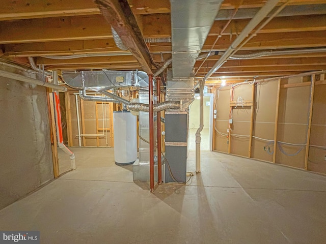 unfinished basement featuring gas water heater and heating unit