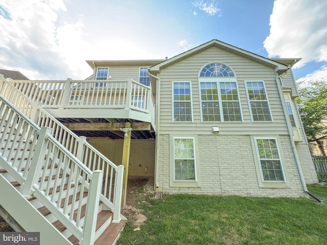 back of house with a yard and a wooden deck