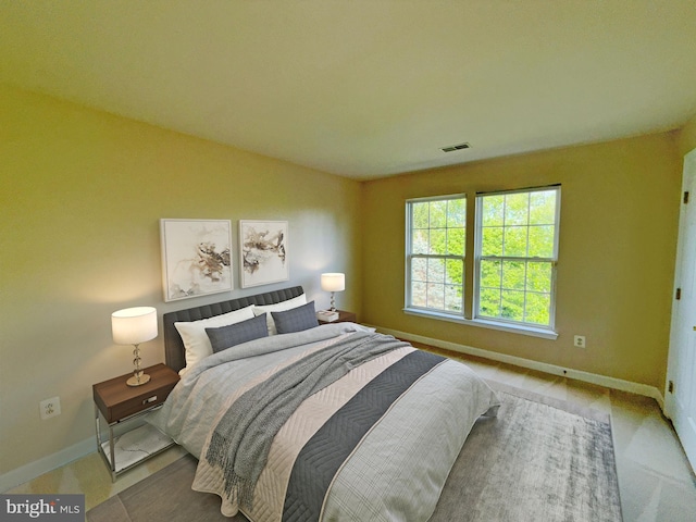 bedroom featuring baseboards and visible vents