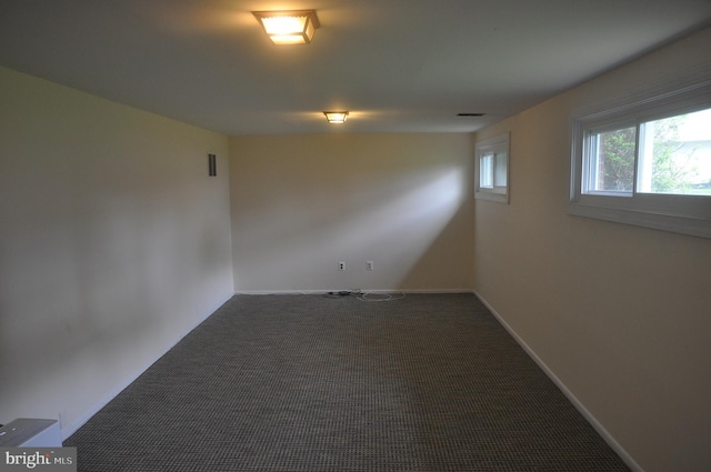 empty room with carpet floors and baseboards