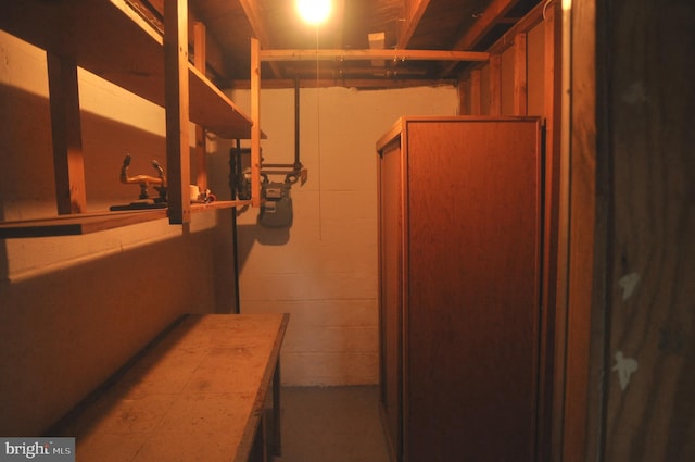 below grade area with gas meter and concrete block wall