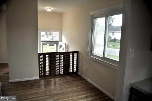 unfurnished room featuring baseboards and wood finished floors