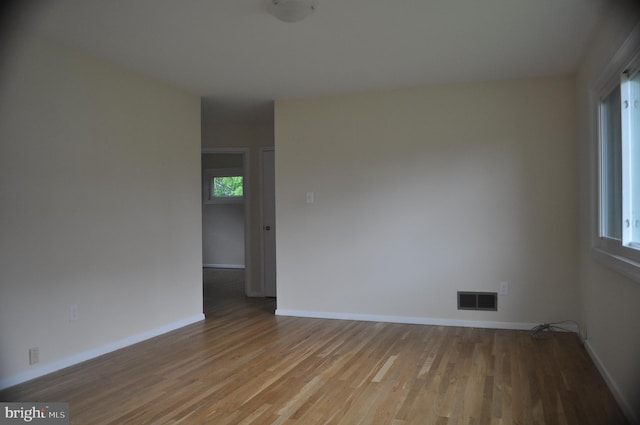 unfurnished room with wood finished floors and baseboards