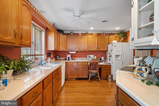 87 Ash Rd, Manahawkin, NJ 08050 - kitchen featuring a sink, ceiling fan, brown cabinets, light countertops, and white appliances