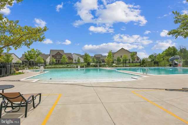 10809 Glowing Hearth Way, Monrovia, MD 21770 - community pool with fence, a patio, and a residential view