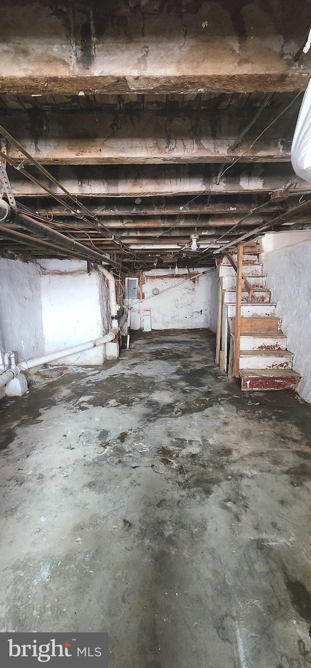 unfinished basement featuring stairs