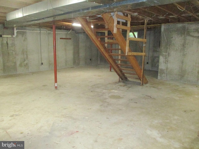 unfinished basement featuring stairway
