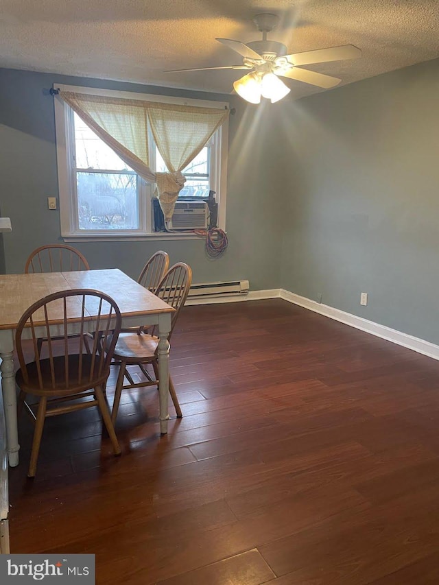 dining room with a textured ceiling, dark wood finished floors, ceiling fan, a baseboard radiator, and baseboards