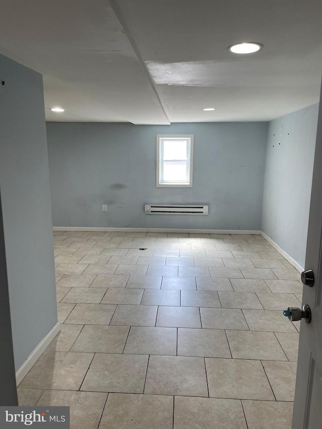 below grade area featuring a baseboard radiator, baseboards, and recessed lighting