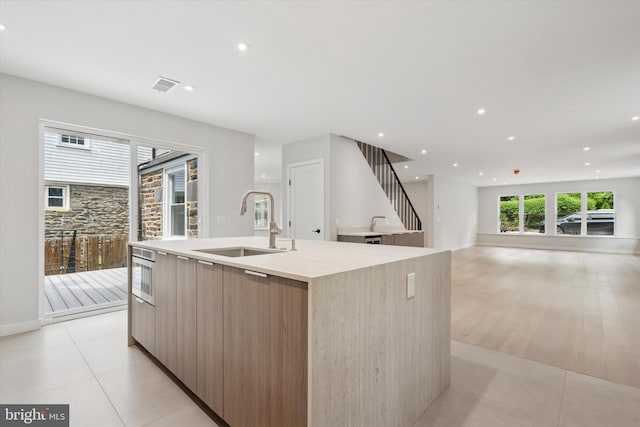 160 Union Ave, Bala Cynwyd, PA 19004 - kitchen with modern cabinets, a sink, an island with sink, light countertops, and recessed lighting