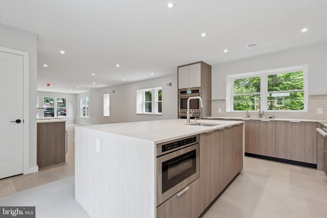 160 Union Ave, Bala Cynwyd, PA 19004 - kitchen with modern cabinets, stainless steel oven, tasteful backsplash, recessed lighting, and a center island with sink