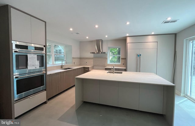 160 Union Ave, Bala Cynwyd, PA 19004 - kitchen with stainless steel double oven, modern cabinets, a sink, wall chimney range hood, and recessed lighting