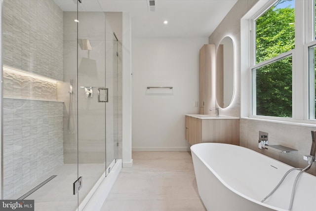 160 Union Ave, Bala Cynwyd, PA 19004 - full bathroom with a freestanding tub, a stall shower, vanity, and baseboards