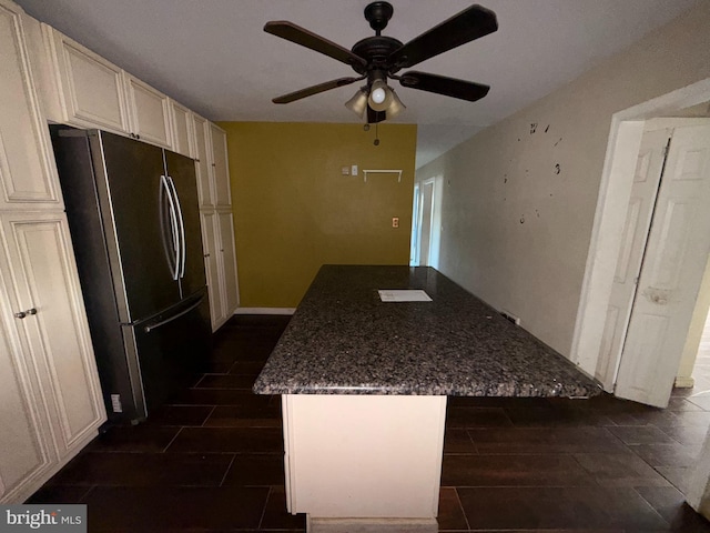 4703 Fayette Dr, Bristol, PA 19007 - kitchen featuring freestanding refrigerator, a ceiling fan, a center island, dark stone countertops, and cream cabinetry