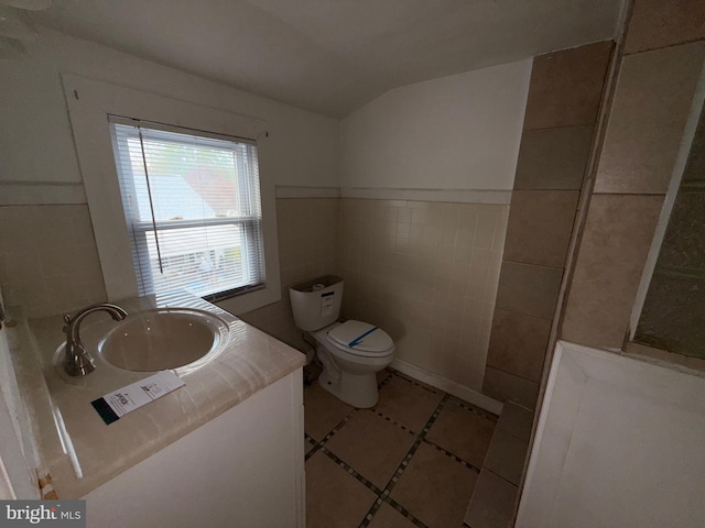 4703 Fayette Dr, Bristol, PA 19007 - bathroom featuring tile walls, toilet, lofted ceiling, tile patterned flooring, and vanity
