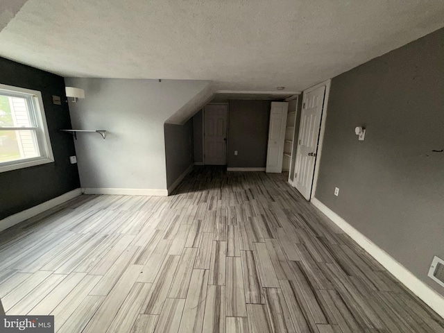 4703 Fayette Dr, Bristol, PA 19007 - unfurnished living room featuring wood finished floors, baseboards, and a textured ceiling