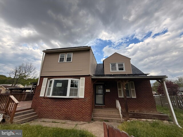 4703 Fayette Dr, Bristol, PA 19007 - view of front of house with brick siding, a shingled roof, and covered porch