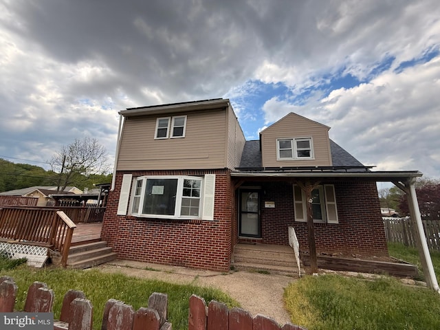 4703 Fayette Dr, Bristol, PA 19007 - view of front of home with brick siding, a porch, a shingled roof, and a wooden deck