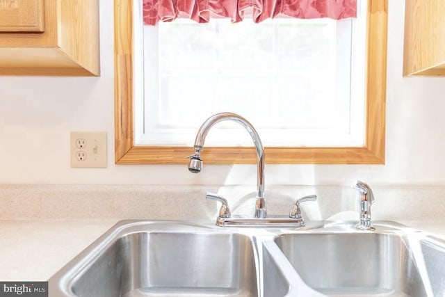 kitchen view of a sink and light countertops