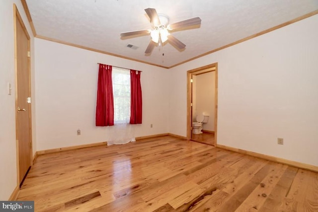 unfurnished room featuring wood finished floors, a ceiling fan, crown molding, and baseboards