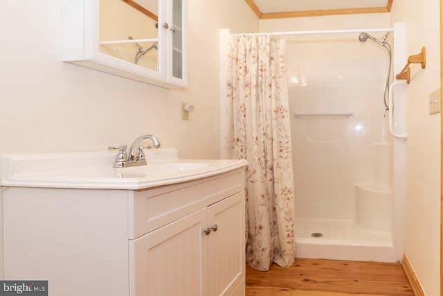 bathroom featuring wood finished floors, curtained shower, and vanity