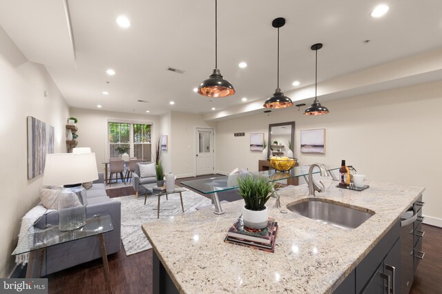 kitchen with a sink, dark wood-style floors, open floor plan, baseboards, and recessed lighting