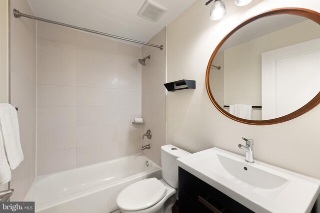 bathroom featuring shower / washtub combination, toilet, and vanity