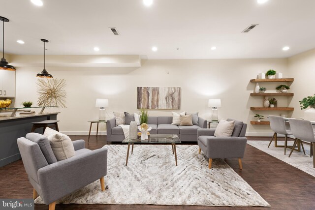 living area with recessed lighting, baseboards, and dark wood-style flooring