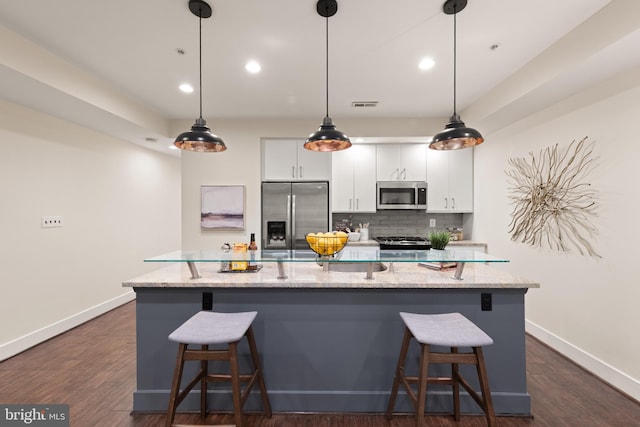 kitchen with appliances with stainless steel finishes, baseboards, white cabinetry, tasteful backsplash, and recessed lighting